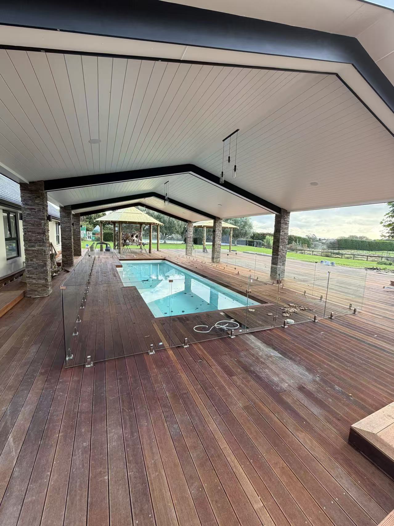 Frameless glass fencing around a covered residential pool